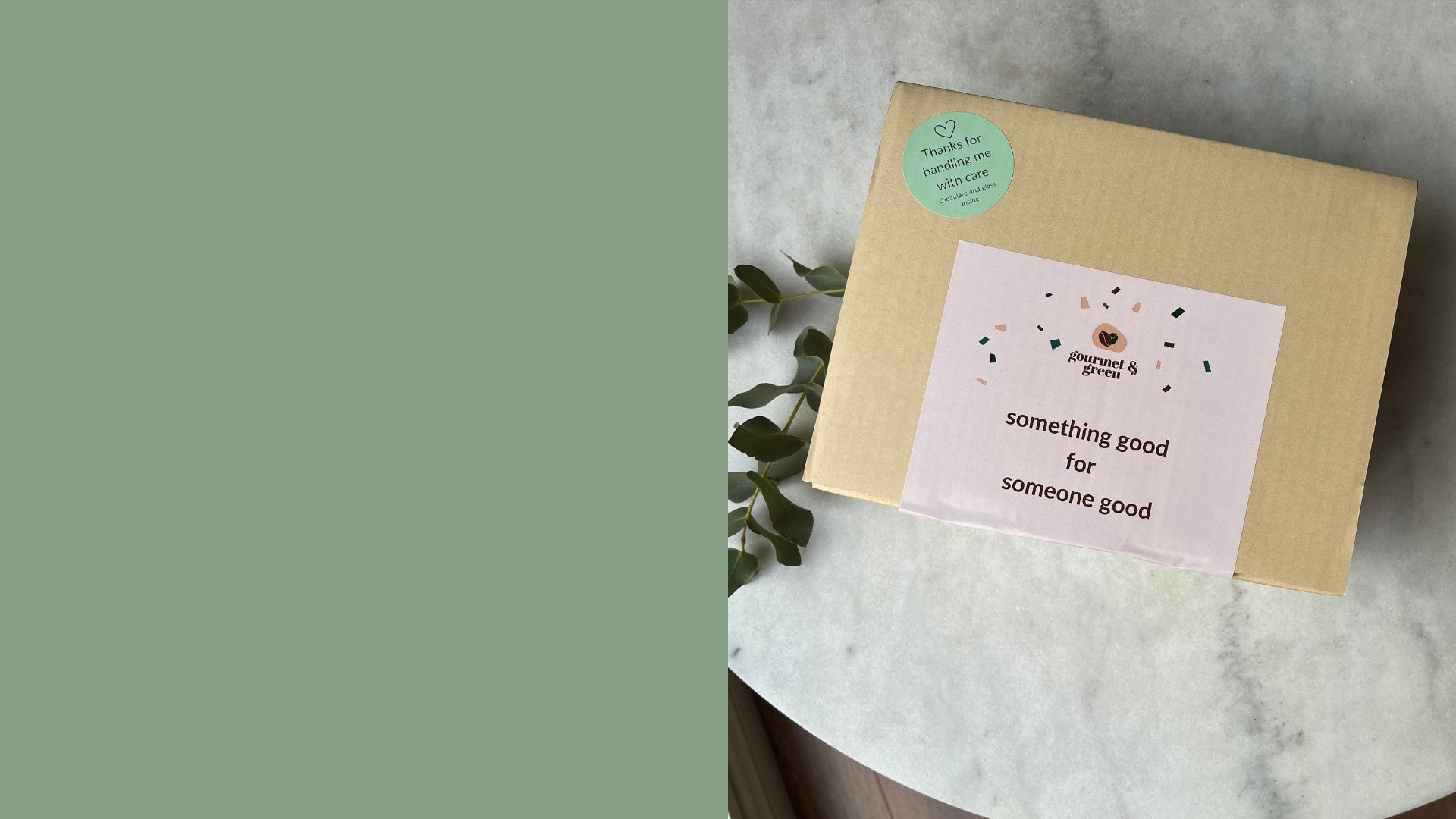 Gift box labelled with a sticker saying "Something good for someone good" on a marble table