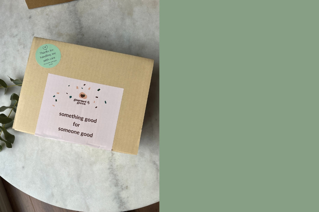 Gift box labelled with a sticker saying "Something good for someone good" on a marble table